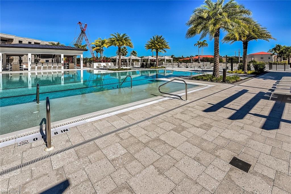 1125 Central Avenue, Unit 373 Naples, FL 34102 - Photo 2 of 49 a view of a swimming pool with a patio