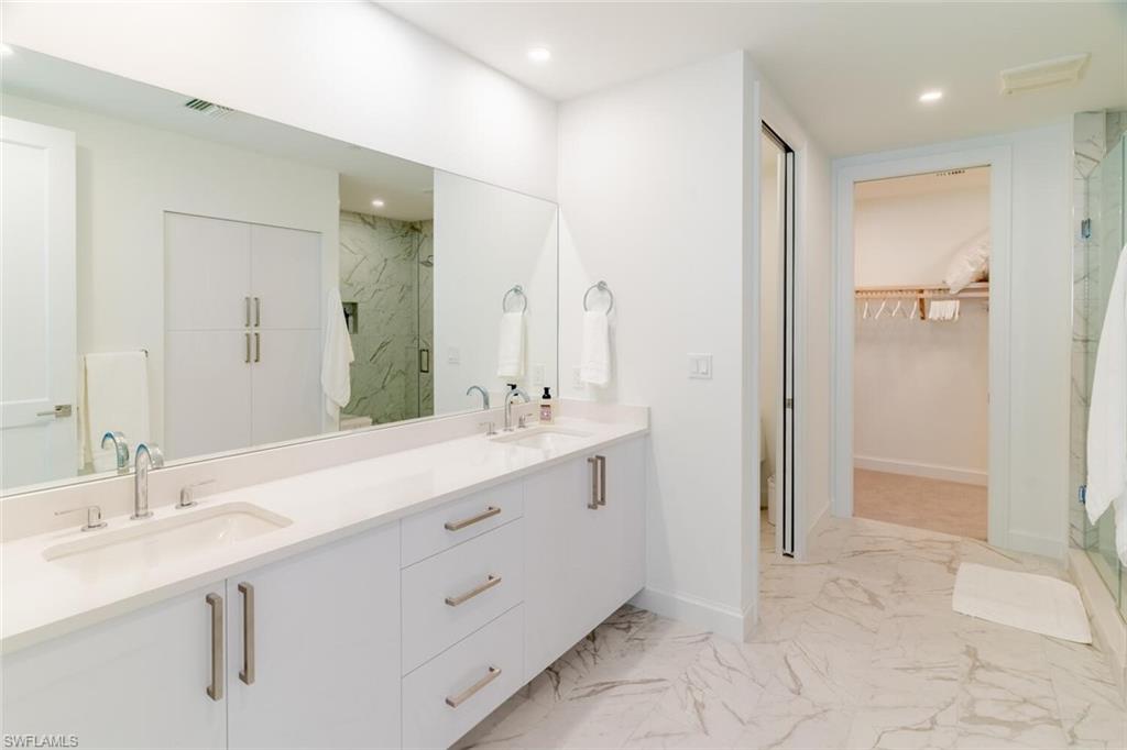 1125 Central Avenue, Unit 373 Naples, FL 34102 - Photo 23 of 49 a bathroom with a double vanity sink mirror and shower