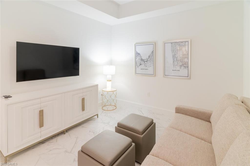 1125 Central Avenue, Unit 373 Naples, FL 34102 - Photo 27 of 49 a living room with furniture and a flat screen tv