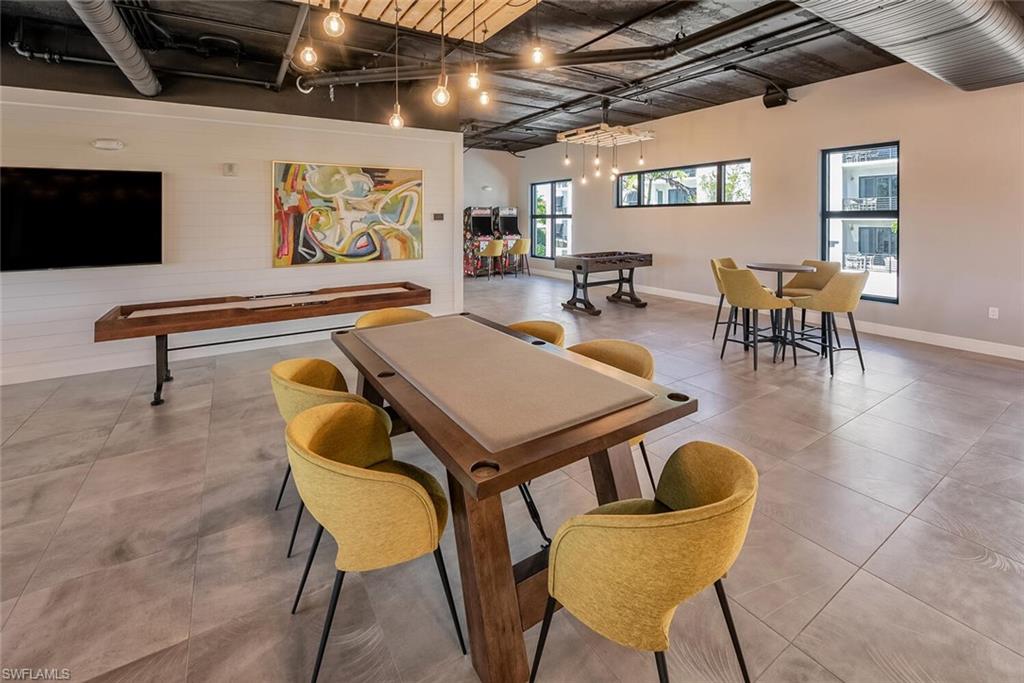 1125 Central Avenue, Unit 373 Naples, FL 34102 - Photo 41 of 49 a dining room with furniture and wooden floor