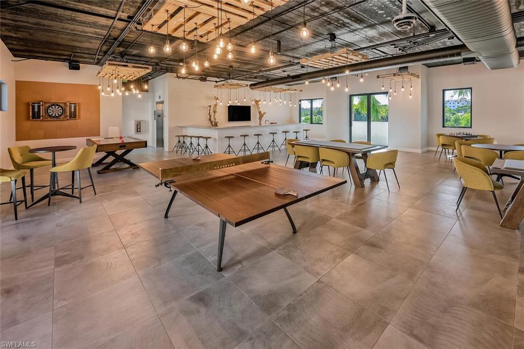 1125 Central Avenue, Unit 373 Naples, FL 34102 - Photo 42 of 49 a living room with furniture and a clock