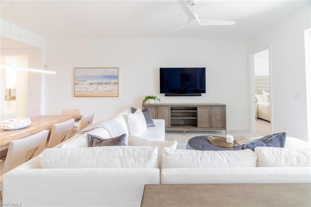 1125 Central Avenue, Unit 373 Naples, FL 34102 - Photo 5 of 49 a living room with furniture and a flat screen tv