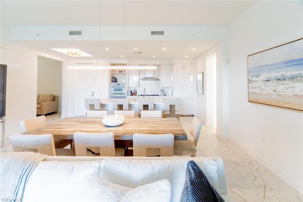 1125 Central Avenue, Unit 373 Naples, FL 34102 - Photo 7 of 49 a living room with stainless steel appliances kitchen island granite countertop furniture and a couch