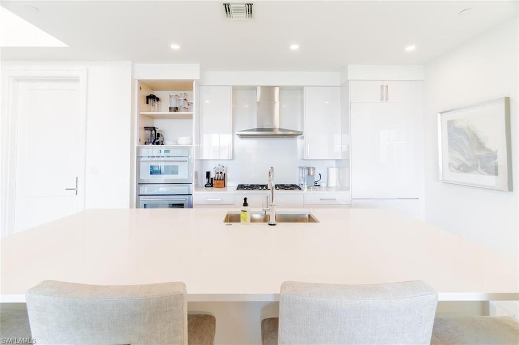 1125 Central Avenue, Unit 373 Naples, FL 34102 - Photo 8 of 49 a kitchen with kitchen island cabinets and refrigerator
