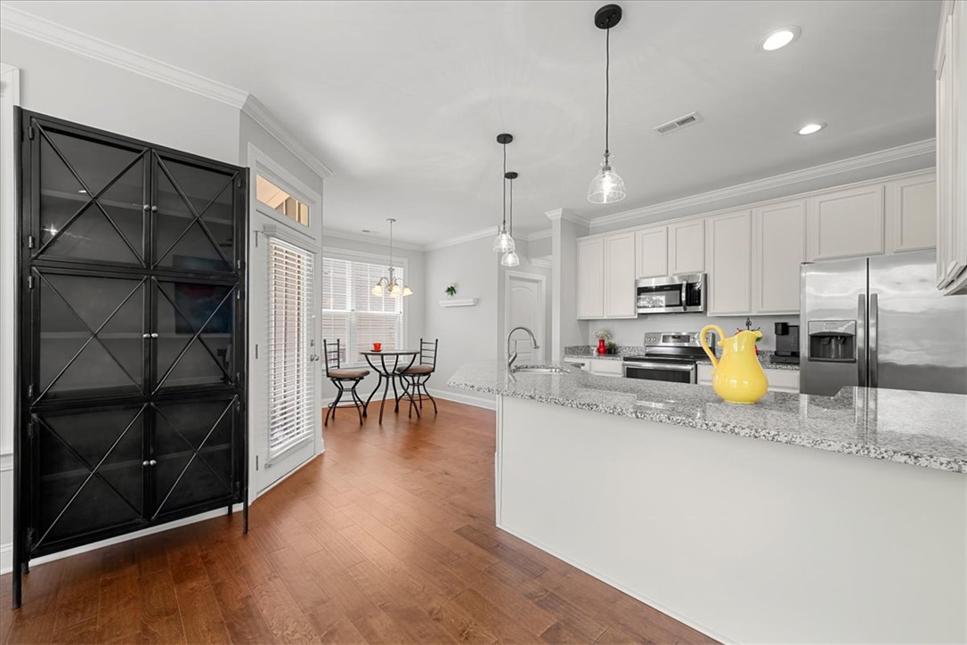 21 Barron Glenn Way Anderson, SC 29621 - Photo 24 of 48 This kitchen showcases a functional layout with rich hardwood floors and an inviting breakfast nook.