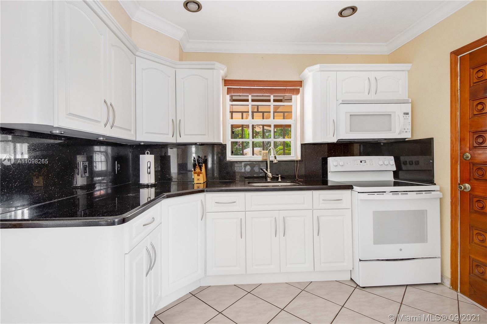 620 Southwest 22nd Road Miami, FL 33129 - Photo 15 of 53 a kitchen with white cabinets a sink and white appliances