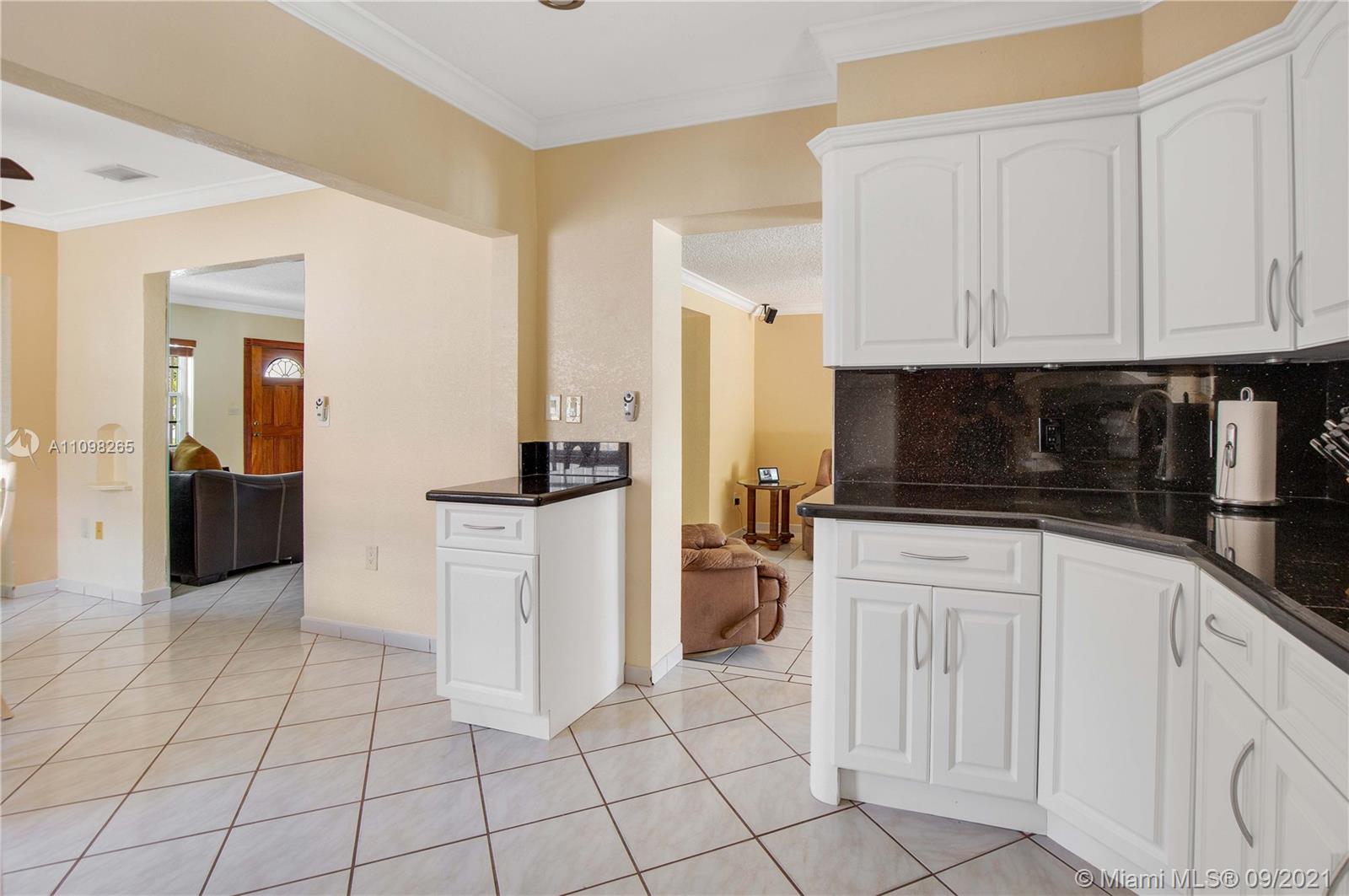 620 Southwest 22nd Road Miami, FL 33129 - Photo 17 of 53 a kitchen with white cabinets a sink and appliances