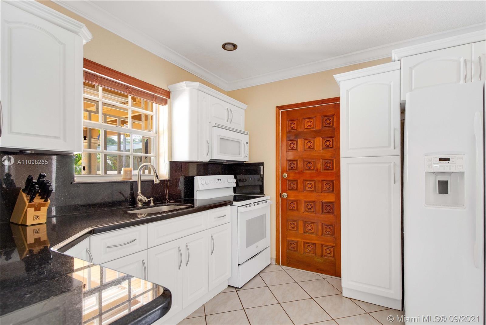 620 Southwest 22nd Road Miami, FL 33129 - Photo 18 of 53 a kitchen with stainless steel appliances a sink window and cabinets