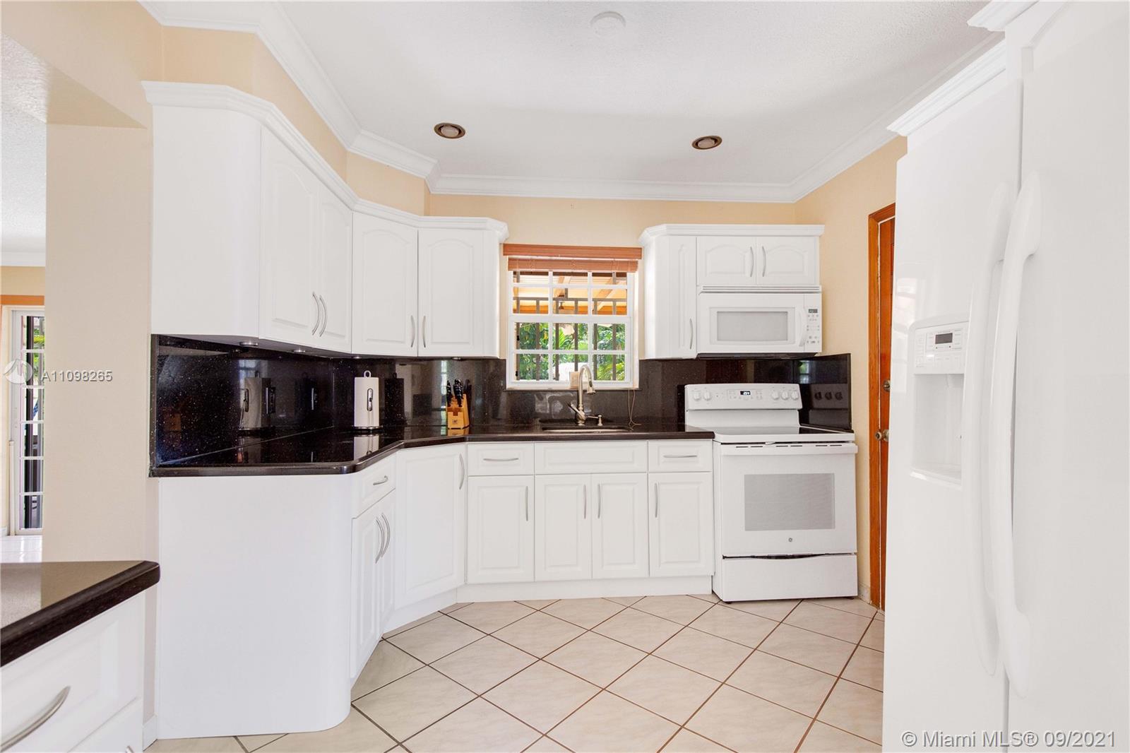 620 Southwest 22nd Road Miami, FL 33129 - Photo 19 of 53 a kitchen with white cabinets a sink and white appliances