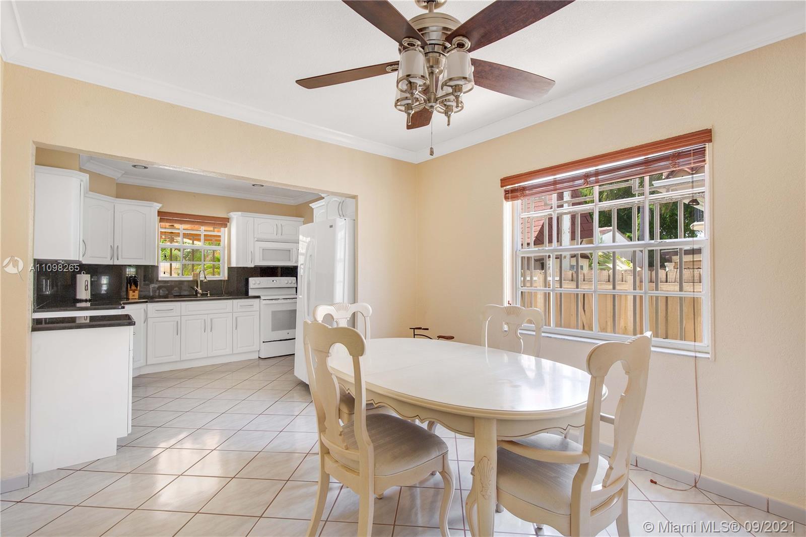 620 Southwest 22nd Road Miami, FL 33129 - Photo 21 of 53 a kitchen with a dining table chairs and refrigerator