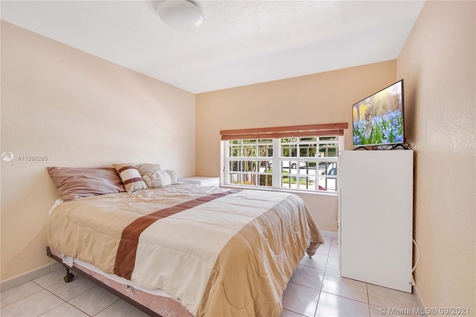 620 Southwest 22nd Road Miami, FL 33129 - Photo 29 of 53 a bed sitting in a bedroom next to a large window