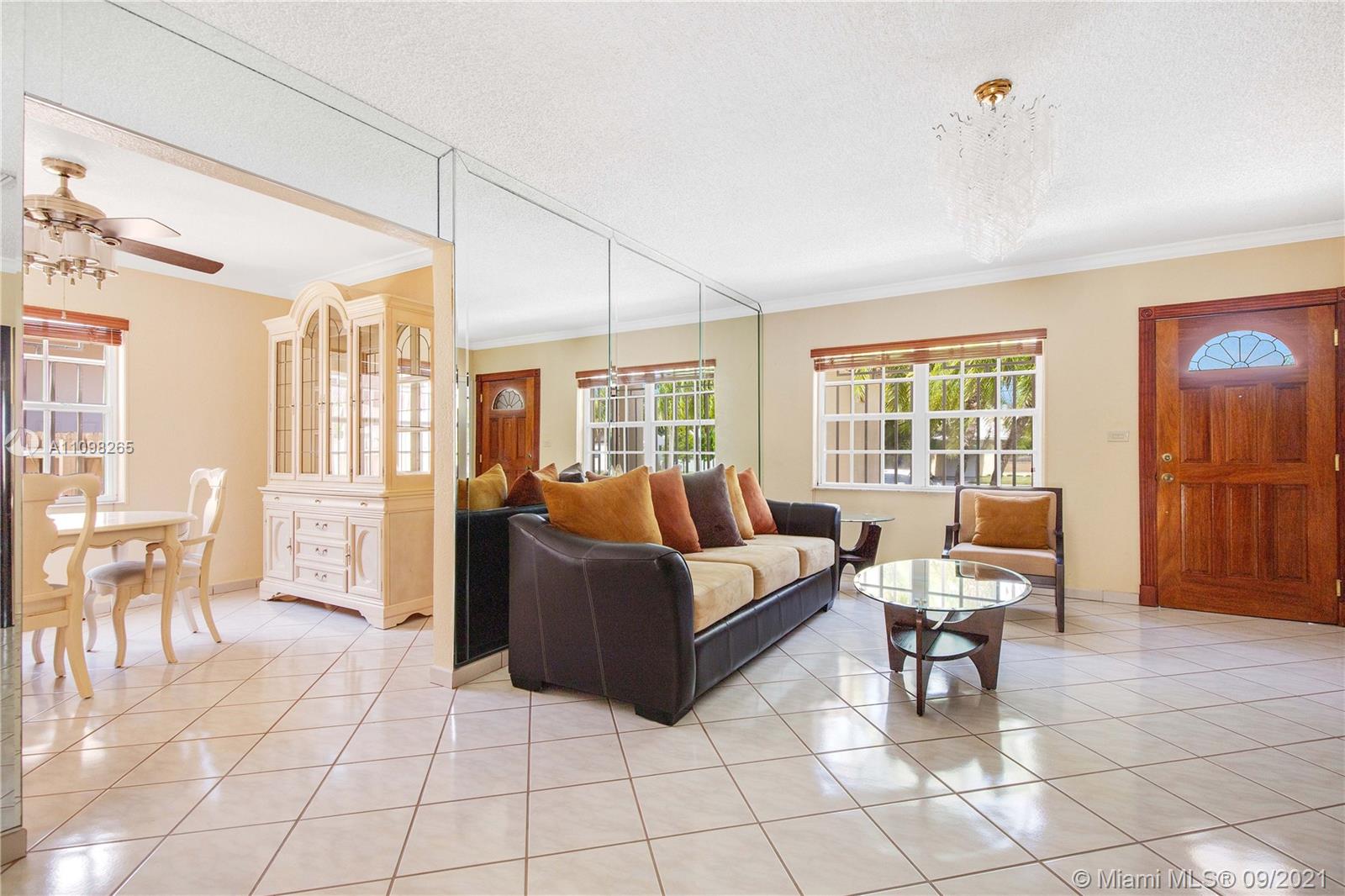 620 Southwest 22nd Road Miami, FL 33129 - Photo 5 of 53 a living room with furniture and a dining table next to a window