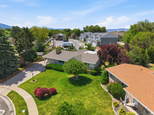 148 Tennyson Avenue Sandy, UT 84070 - Photo 49 of 55 Expansive green lawn with mature trees and established landscaping