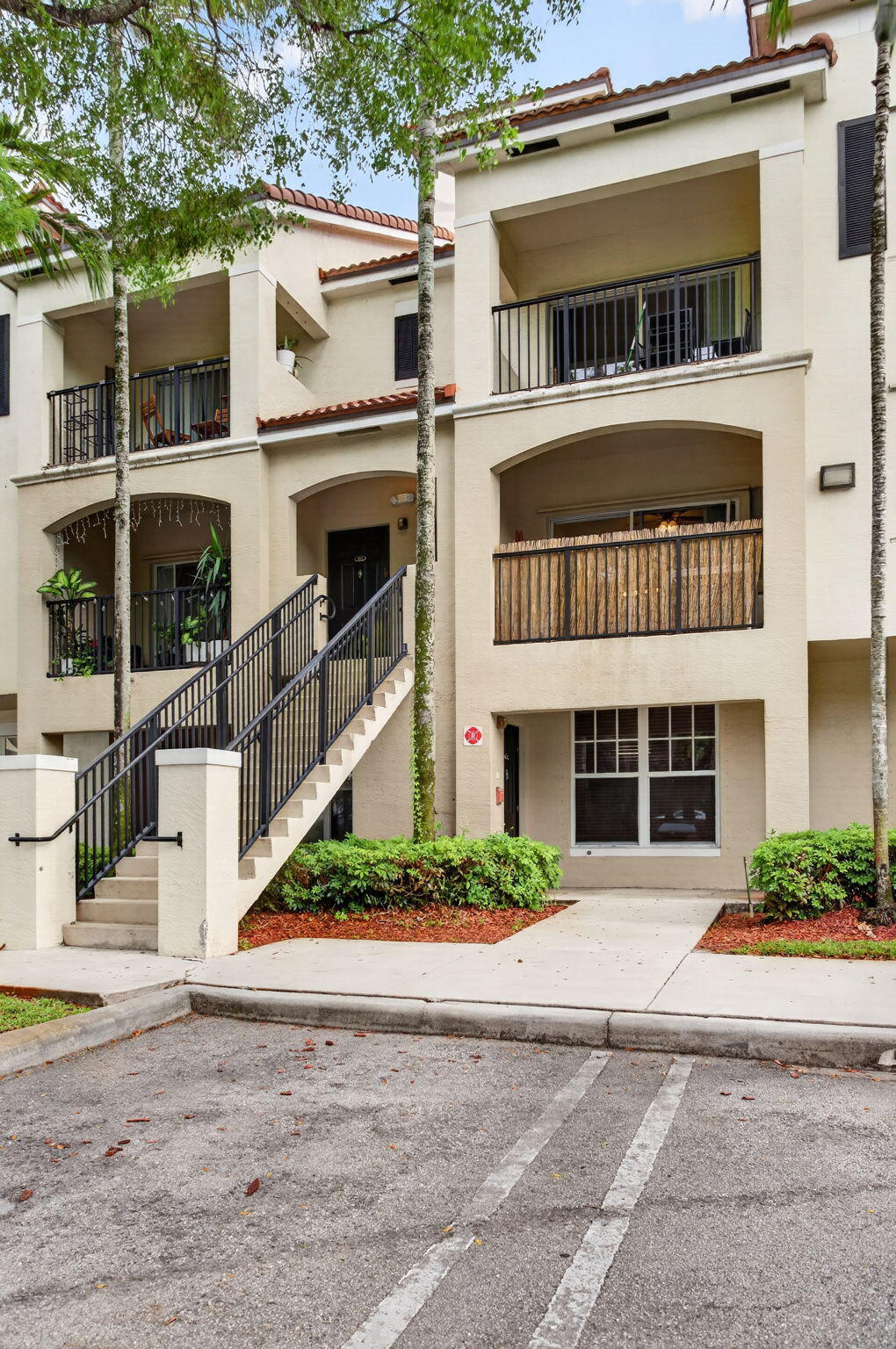 5880 West Sample Road, Unit 206 Coral Springs, FL 33067 - Photo 2 of 37 a front view of a house with a yard and garage