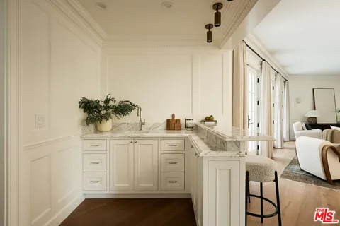 a bedroom with a bed and a table in it with window