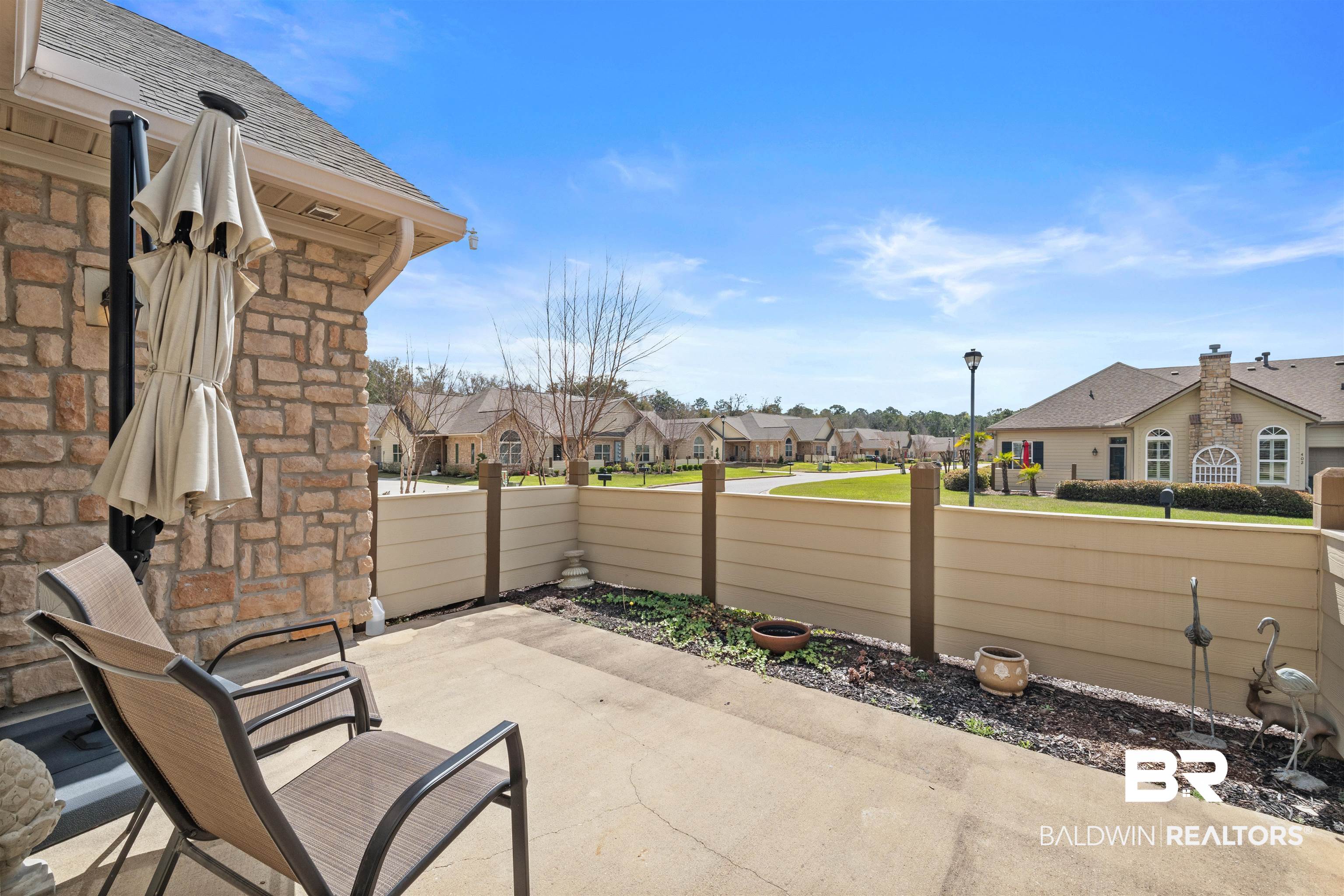 301 Holmes Avenue, Unit 301 Foley, AL 36535 - Photo 38 of 54 View of patio / terrace featuring a residential view and fence