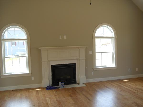 7 Quail Ridge Road Merrimac, MA 01860 - Photo 9 of 14 an empty room with wooden floor fireplace and windows