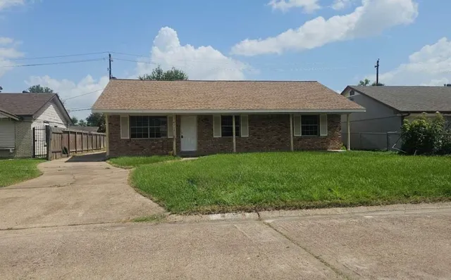a front view of a house with a garden and plants
