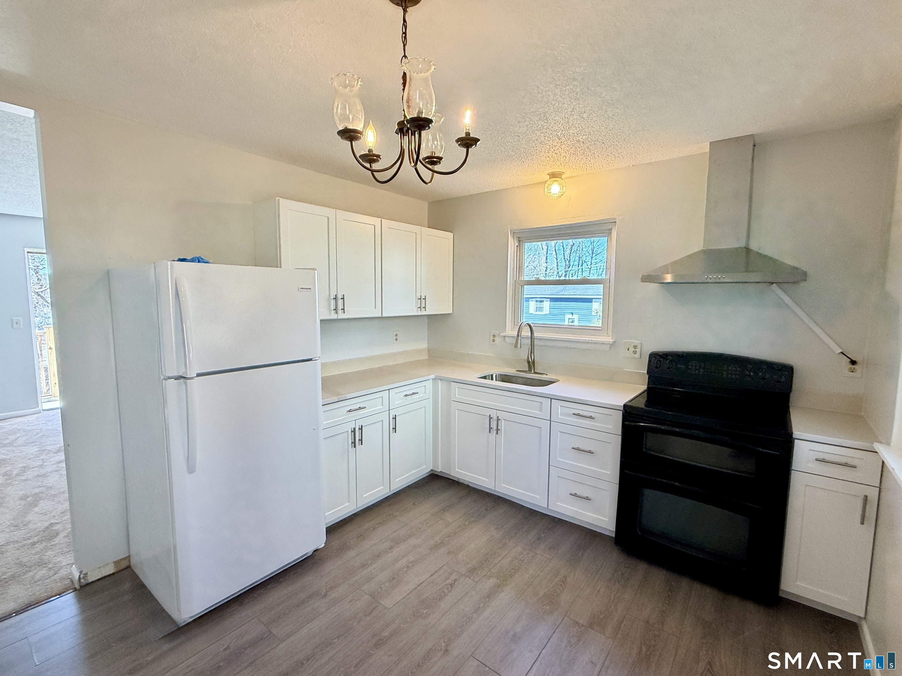 84 Wilmot Street Torrington, CT 06790 - Photo 2 of 18 a kitchen with a refrigerator a sink and dishwasher a stove top oven