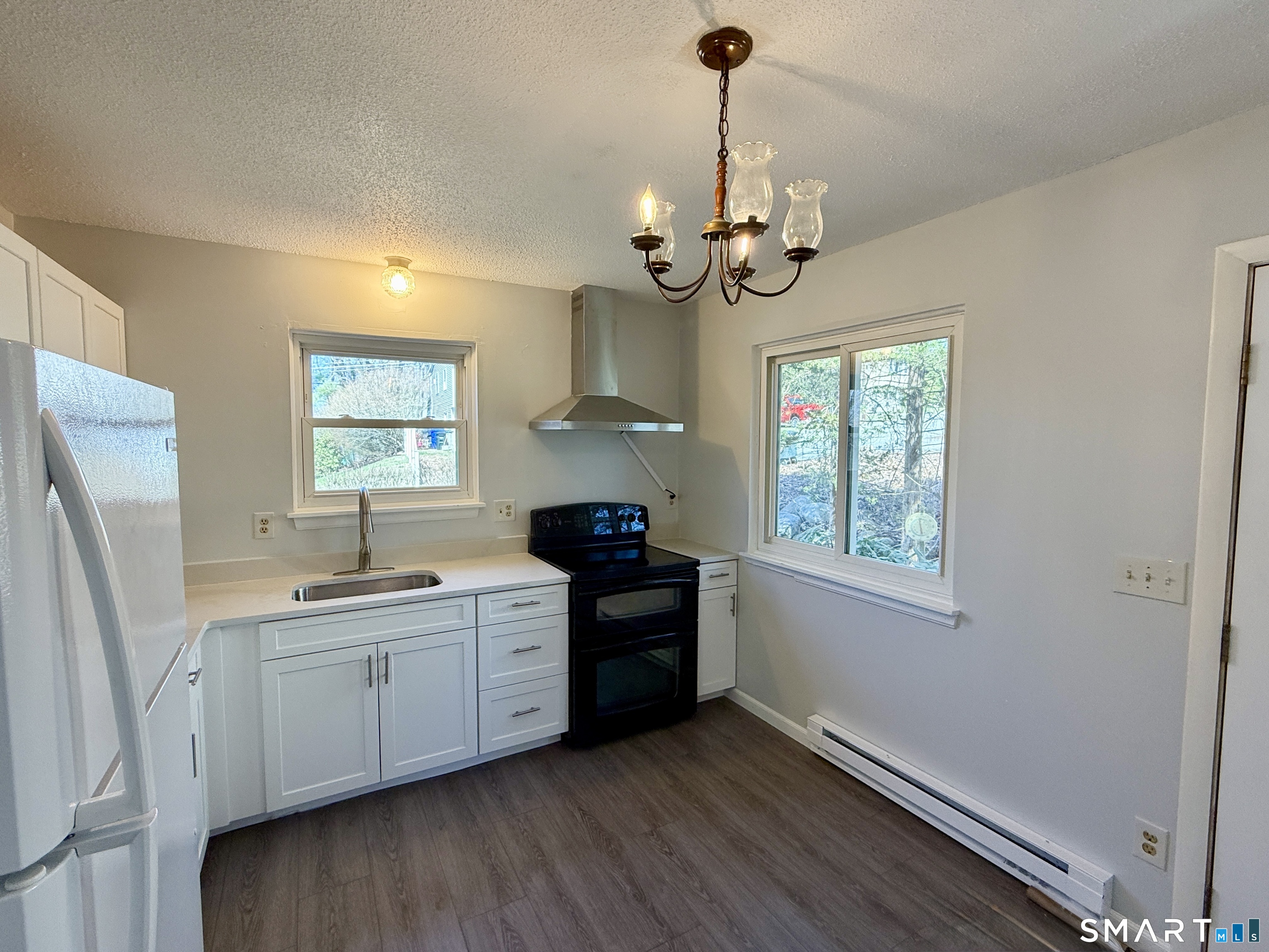 84 Wilmot Street Torrington, CT 06790 - Photo 3 of 18 a kitchen with stainless steel appliances a stove sink and refrigerator