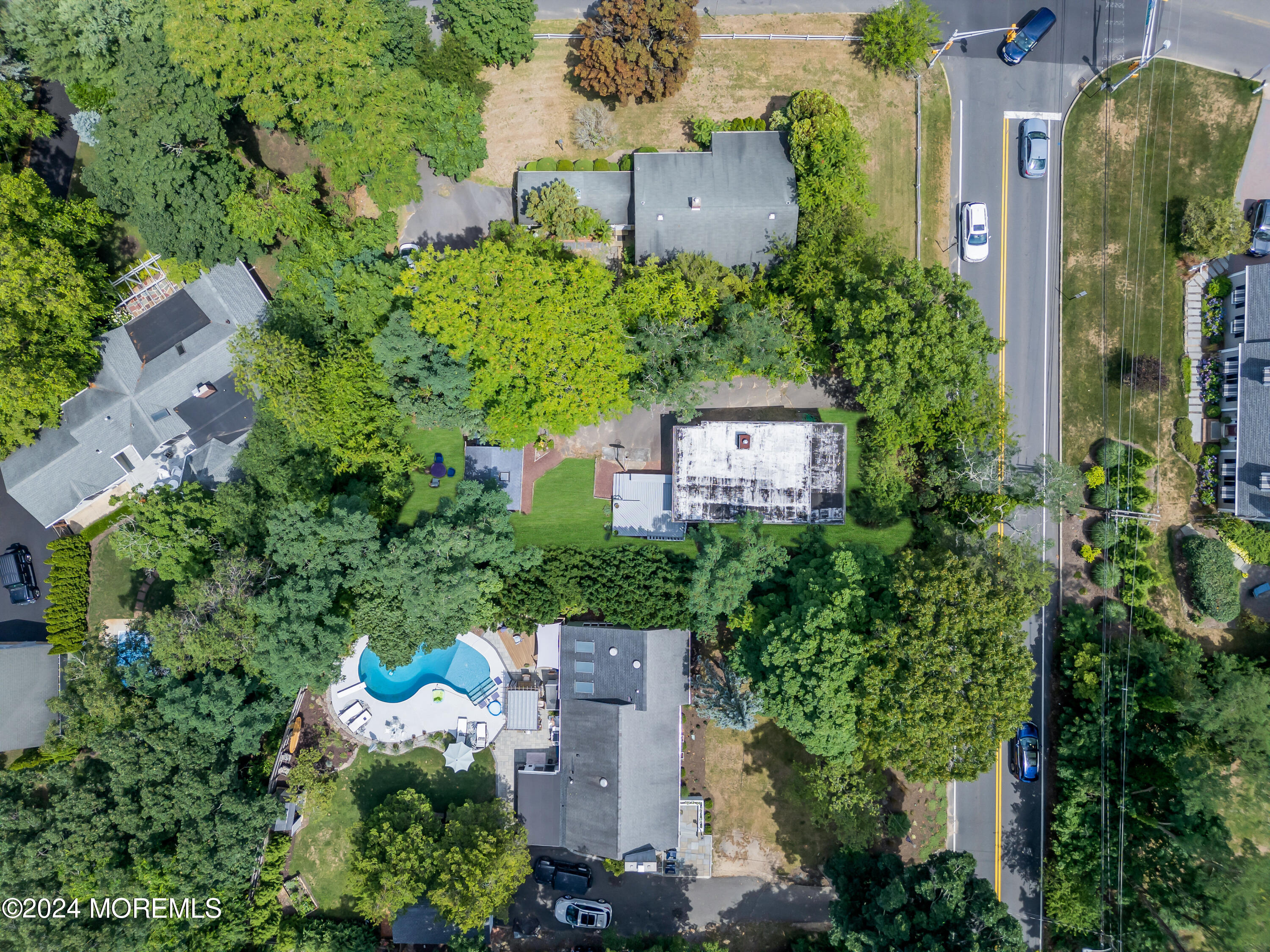 an aerial view of a house with a yard and garden