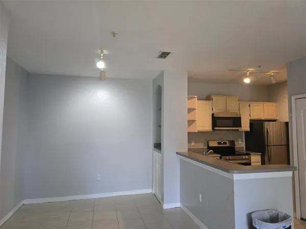 a kitchen with stainless steel appliances a refrigerator and a stove top oven