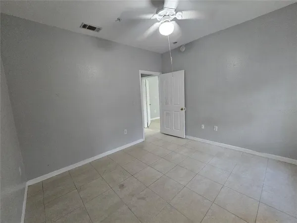 an empty room with a empty space and a ceiling fan