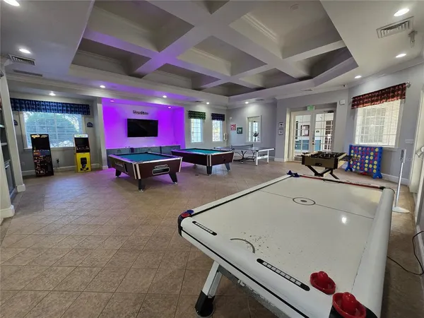a living room with furniture gym equipment and a large window