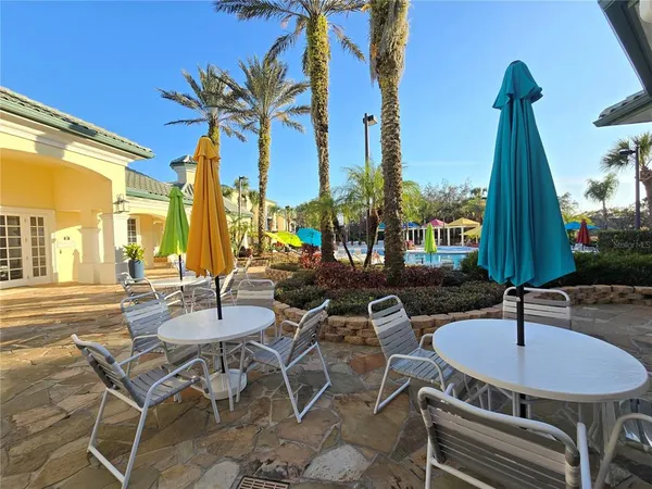 a view of a patio with a table and chairs