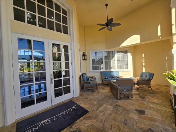 a living room with furniture windows and dining table