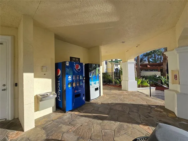 a view of a hallway with a view of living room and bathroom