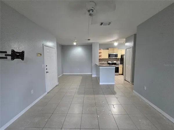 a view of a kitchen with a sink and a refrigerator