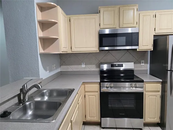 a kitchen with granite countertop a stove and a sink
