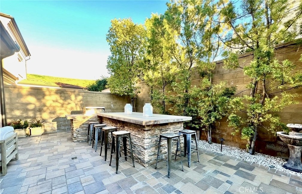 68 Chianti Irvine, CA 92618 - Photo 15 of 17 a view of a patio with table and chairs and potted plants