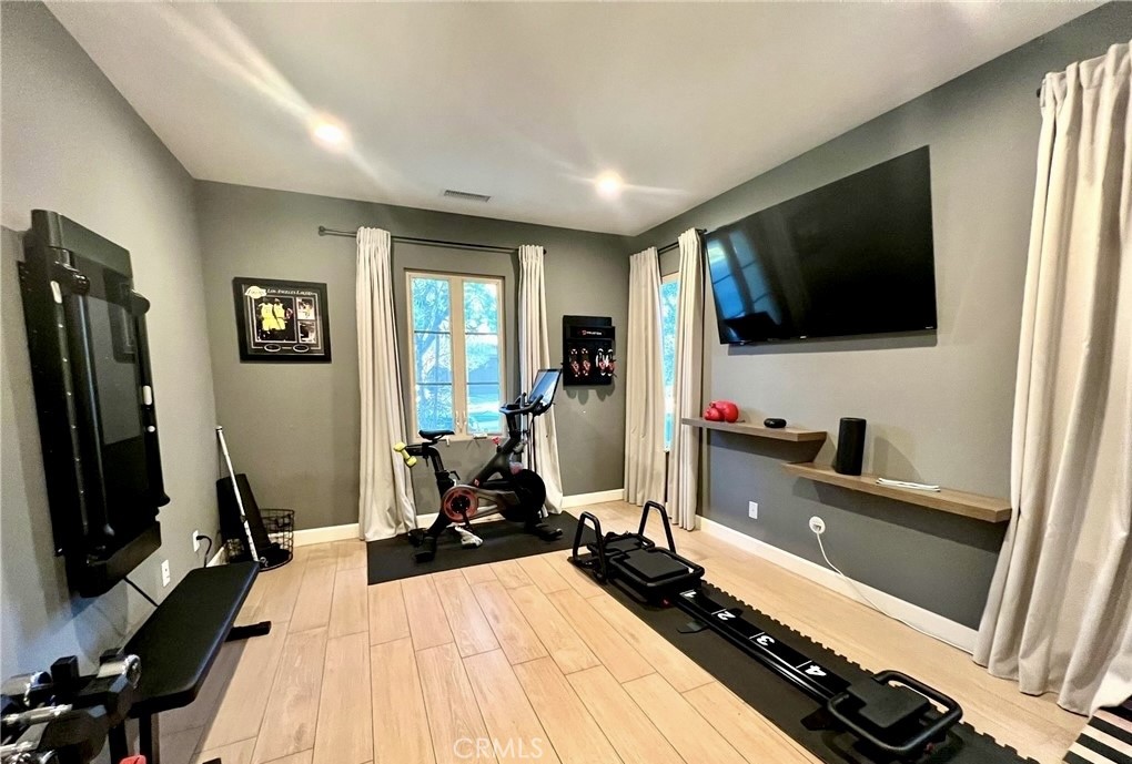 68 Chianti Irvine, CA 92618 - Photo 16 of 17 a room with a bed and a flat tv screen on the wall