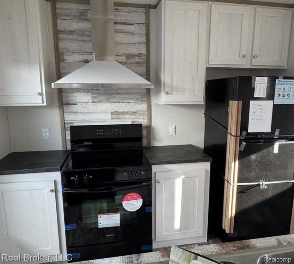 2995 Detroit Road Niles, MI 49120 - Photo 5 of 13 Kitchen featuring a stainless steel range hood, black electric range, and black refrigerator