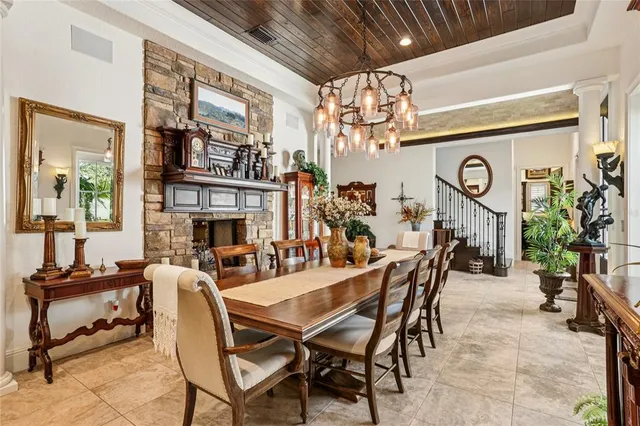 a view of a dining room with furniture a chandelier and a rug