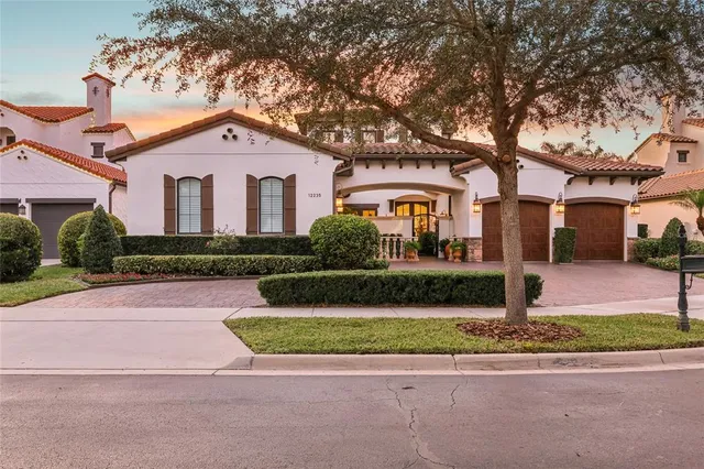 a front view of a house with a yard and garage