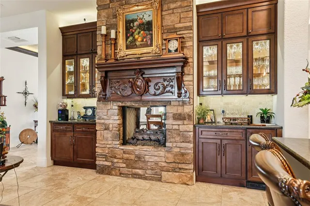 a bathroom with a granite countertop sink and large mirror