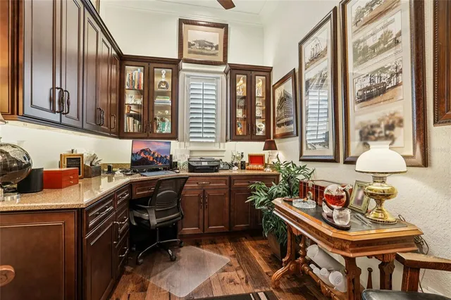 a patio with a table and chairs and potted plants
