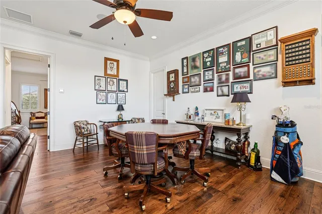 a view of a patio with couches and table and chairs under an umbrella
