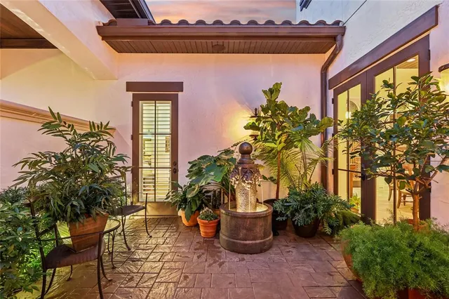 a house with potted plants in front of door
