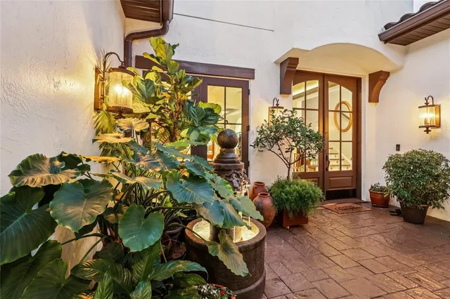 a view of a dining room with furniture and a chandelier