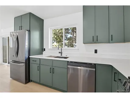 a kitchen with a refrigerator and a sink