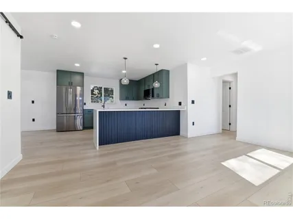 a view of kitchen and refrigerator