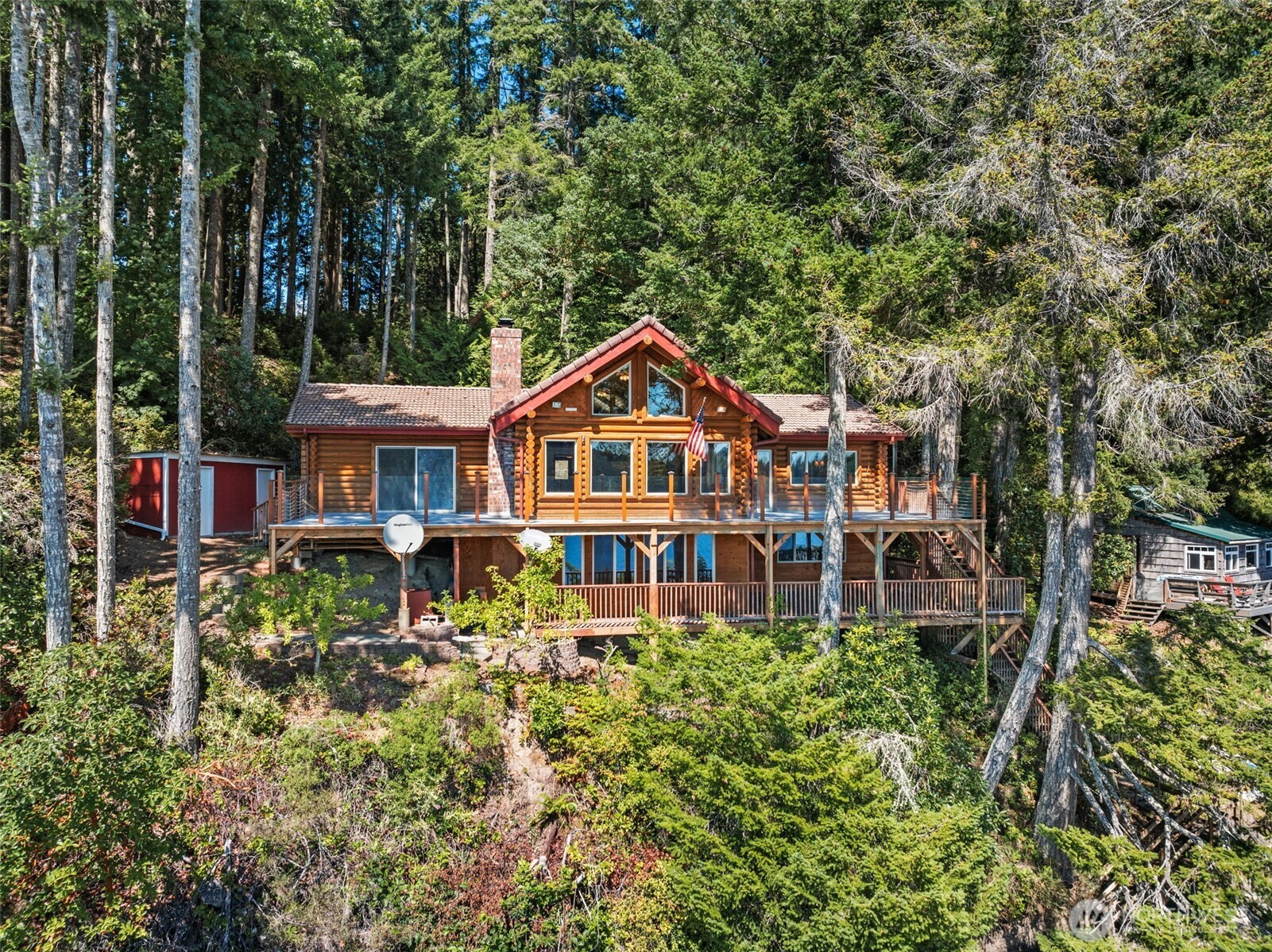 1236 East Island View Road Grapeview, WA 98546 - Photo 2 of 40 a front view of a house with a yard and fountain