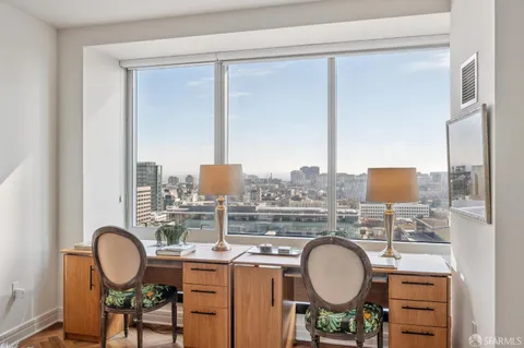 a view of a balcony with two chairs and a table