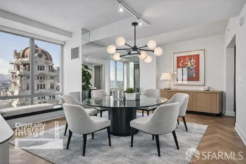 a view of a dining room with furniture and chandelier