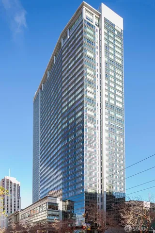 a living room with a couch and a potted plant