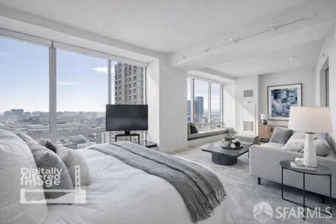 a bedroom with furniture and a flat screen tv